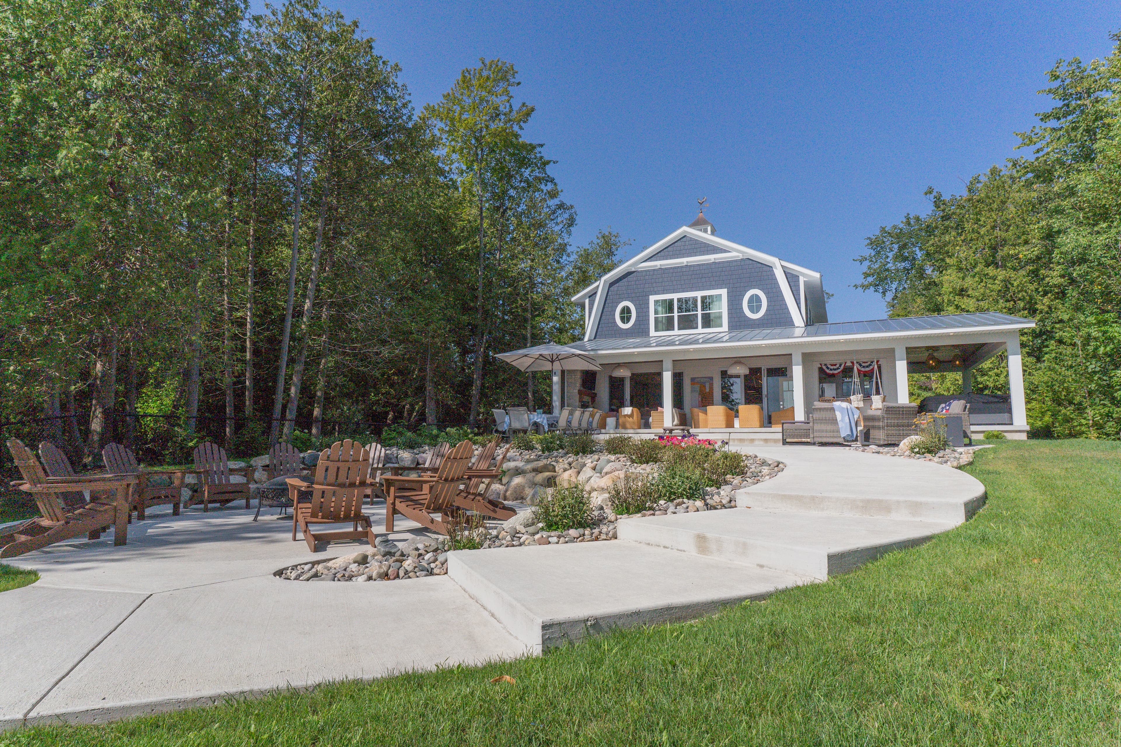 Nautical gambrel style custom lakefront home exterior designed and built by Ver Woert Construction on Lake Charlevoix Michigan