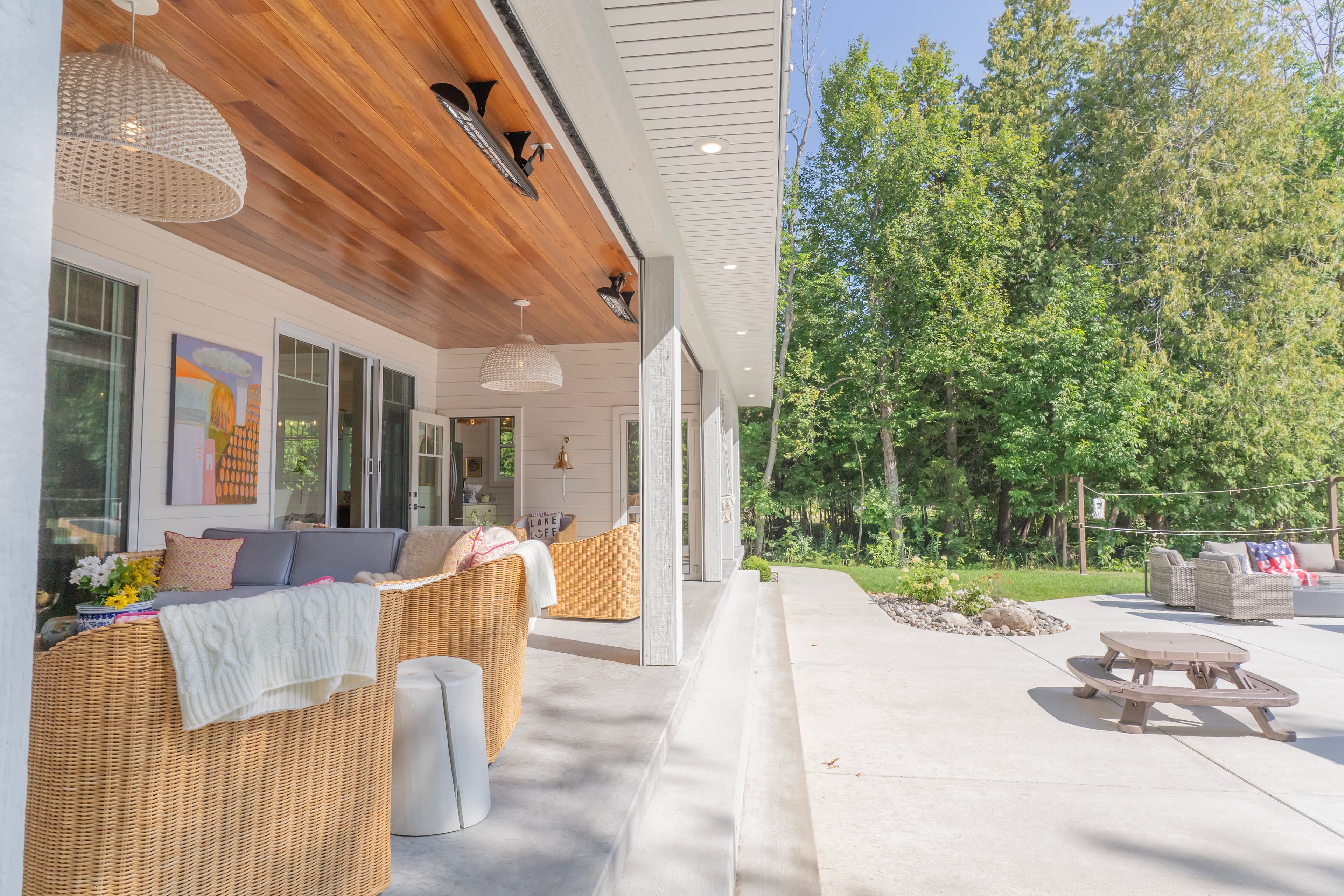 Coastal gambrel roof custom home exterior with cedar shingle siding on Lake Charlevoix Michigan custom home builder